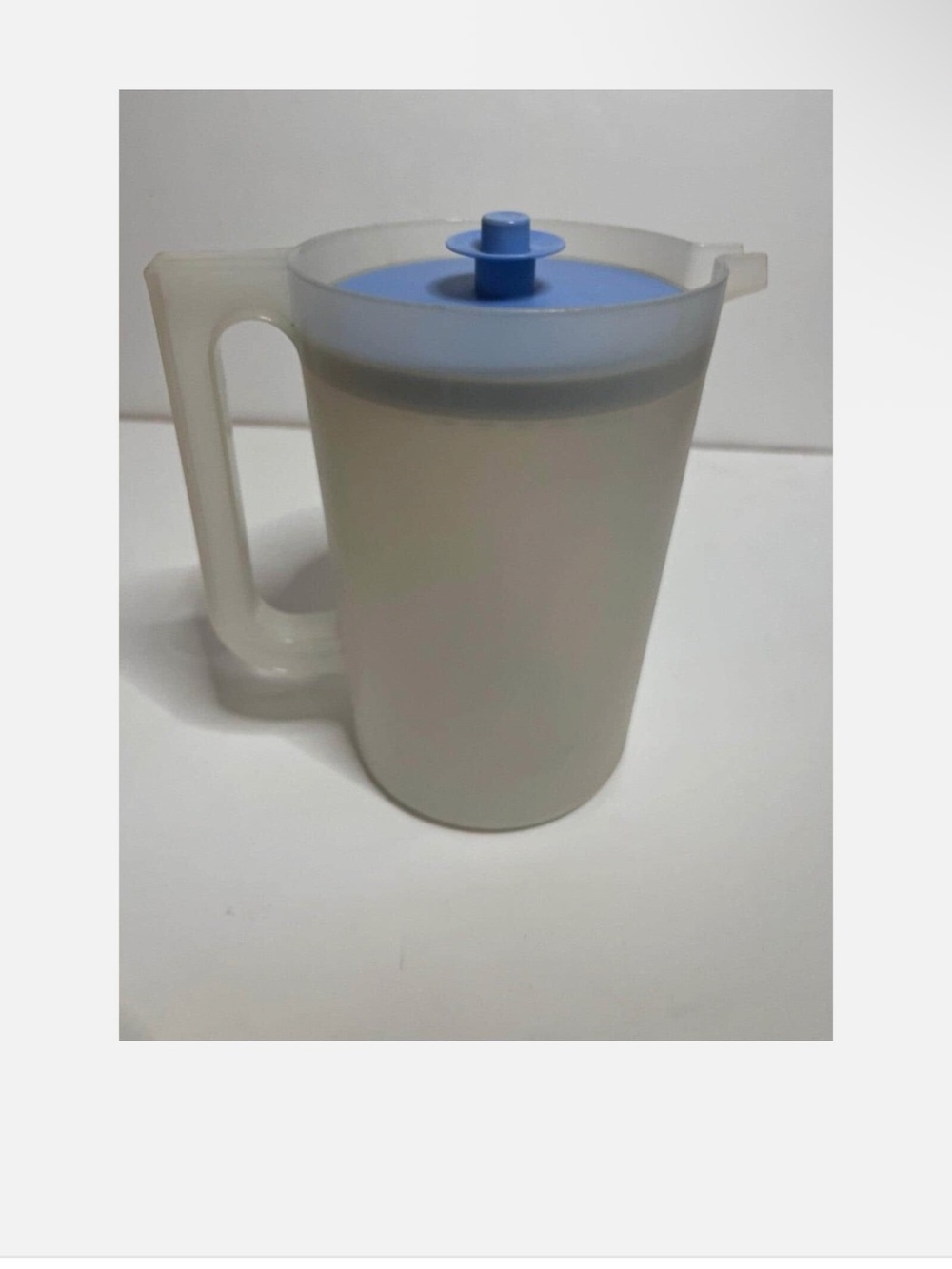Vintage Tupperware juice container with blue push button lid